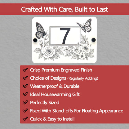 Decorative house number sign with butterflies and flowers on a grey background with text about product features.