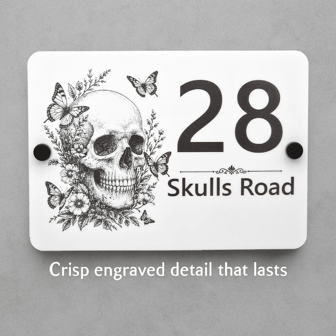 Close-up of the personalised Skull & Butterfly house sign showing crisp laser engraved details on white acrylic.